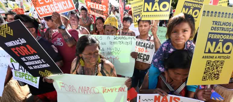 Indigenous people protesting at the Free Land protest camp in Brasilia, 2024 Indigenous people protesting with numerous placards