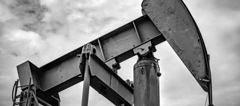Oil production in the heart of the Congo Basin would be devastating for the climate, nature and people Oil pumpjack with a cloudy sky in the background