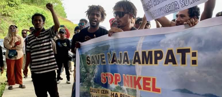 Save Raja Ampat: Stop nickel! Revoke the mining license! Protesters with banner “Save Raja Ampat: Stop Nickel”