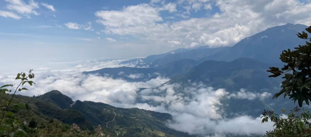 Mountain landscape in the Rio Blanco area Mountain landscape with white clouds hugging the ground and above in the sky