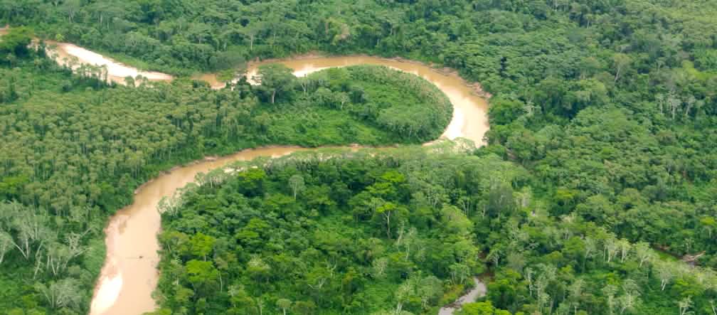 A river meanders through rainforest in Peru Aerial view of the Peruvian Amazon