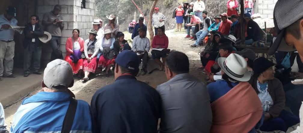 A gathering of women after the murder View of a gathering of local people outside simple buildings