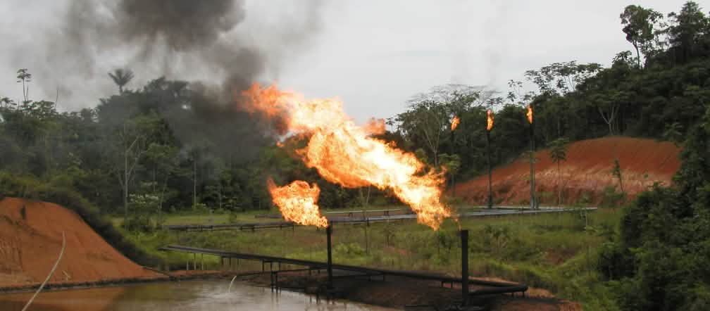 Oil industry gas flaring in the Amazon rainforest of Ecuador Gas flaring, pipelines and oil ponds in the rainforest