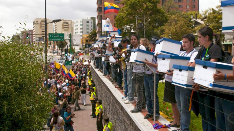 A large group of young people at the National Electoral Commission of Ecuador in Quito in 2014, delivering 757,000 signatures calling for a referendum on Yasuní National Park.