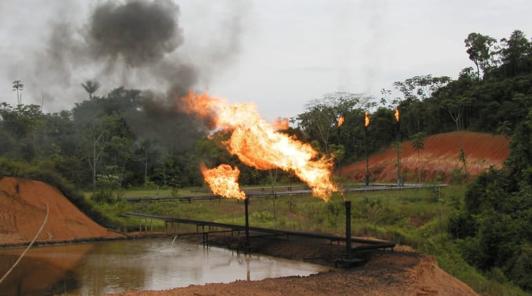 Gas flaring, pipelines and oil ponds in the rainforest