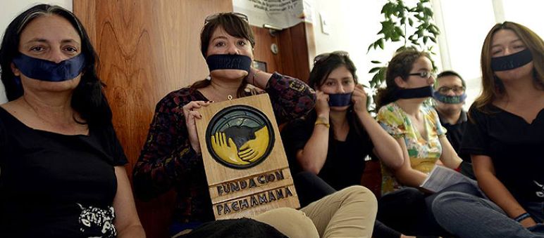 Silent protest of the environmental and human rights activists in Quito Activists with a taped mouth in Quito